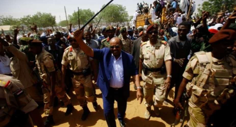 Sudanese President Omar al-Bashir C waves to the crowd during a visit to El Daein in Eastern Darfur on April 5, 2016.  By Ashraf Shazly AFPFile