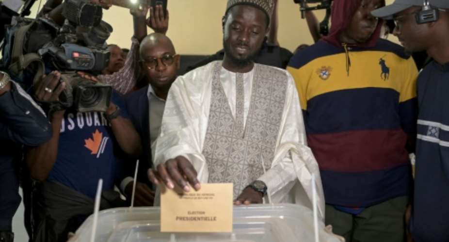 Bassirou Diomaye Faye, 44, votes in his home village of Ndiandiaye in Senegal's presidential election.  By SEYLLOU AFPFile