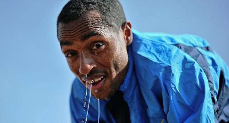 Ethiopia's long distance runner Kenenisa Bekele takes a break at his training grounds in Sululta near Addis Ababa, on January 16, 2014.  By Carl de Souza AFP