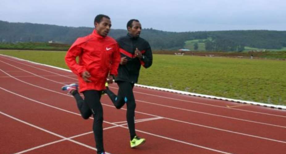 Ethiopian running greats Kenenisa Bekele left and his brother Tariku train outside Addis Ababa, September 1, 2013.  By Jenny Vaughan AFPFile