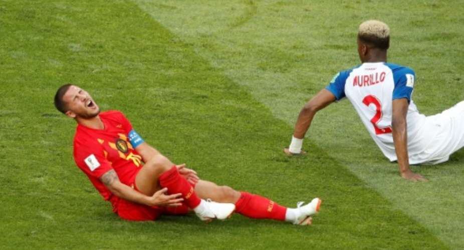 Belgium coach Roberto Martinez is concerned star forward Eden Hazard L, seen here after a bruising tackle by Panama's defender Michael Murillo, will get more rough treatment against Tunisia..  By Odd ANDERSEN AFP