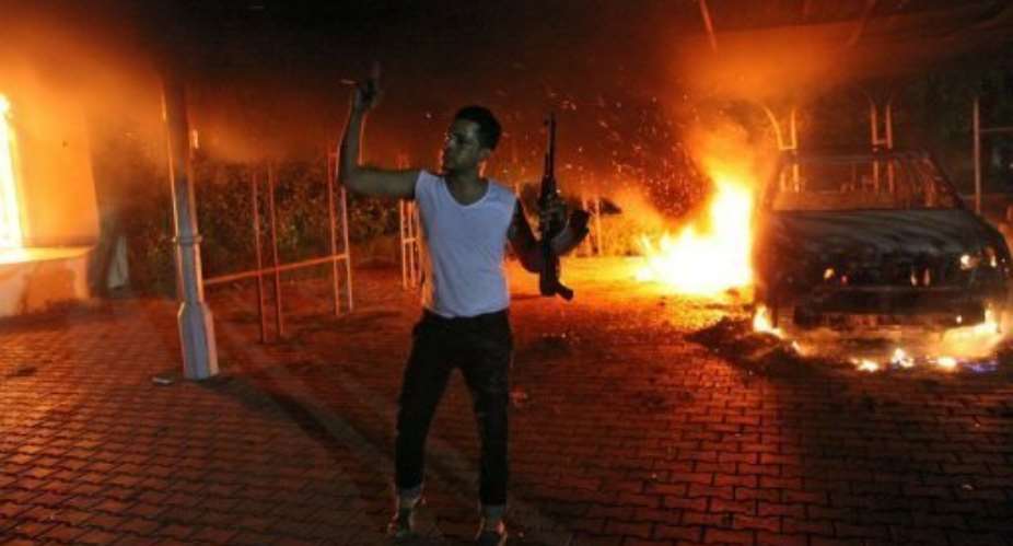 A man waves his rifle inside the US consulate compound in Benghazi late on September 11, 2012.  By  (AFP/File)