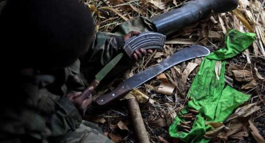 A Ma Ma Nyatura fighter services an AK-47 magazine in a hut at a hilltop base in Kiseguro, around 90km north of Goma, in the east of the Democratic Republic of Congo.  By Phil Moore AFPFile