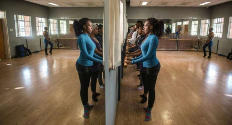 South African ballet dancers attend a class thought by Cuban dance teacher Maria Torguet, at a studio in Soweto, Johannesburg.  By Mujahid Safodien AFP