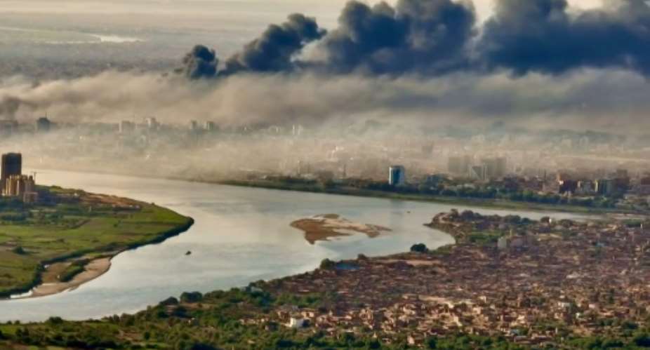 Black smoke covers the sky above the capital Khartoum.  By Abdelmoneim SAYED (AFP)