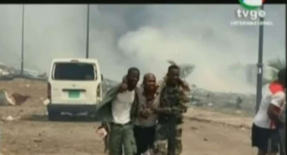 Blast victim: Equatorial Guinea's state-run TVGE showed an injured man being assisted by soldiers.  By - TVGEAFP