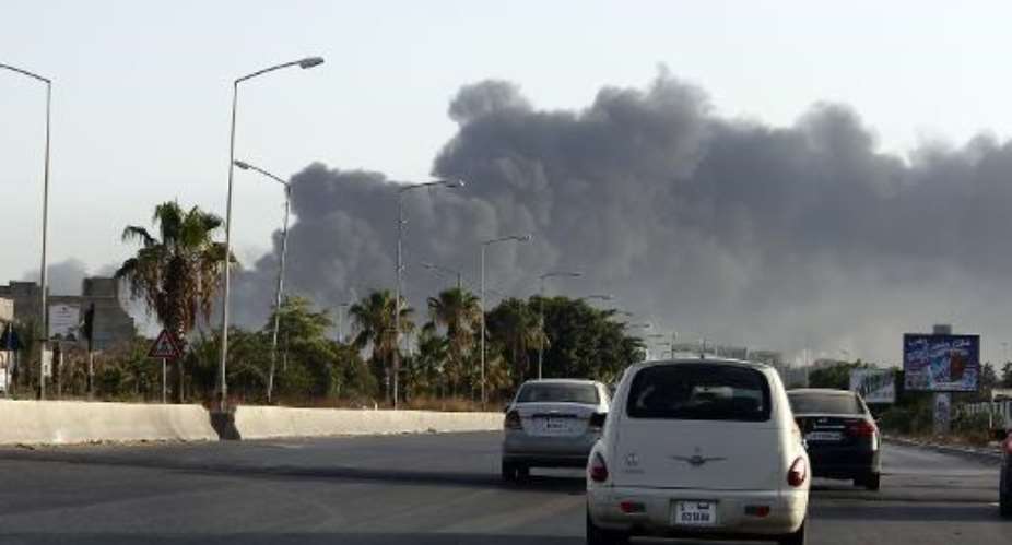 Smoke billows from a petrol depot set ablaze during clashes between rival militias near the Tripoli's international airport, on the outskirts of the capital, on August 13, 2014.  By - AFPFile