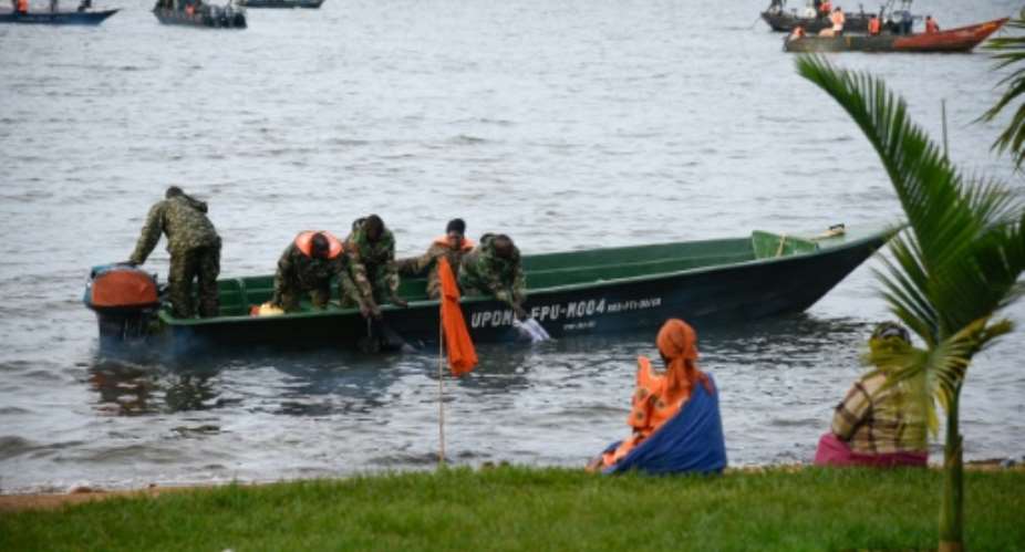 Boat rides, often featuring drinking, dancing and music, are popular on Lake Victoria. Here, navy personnel search for victims of Saturday's disaster.  By Isaac Kasamani AFP