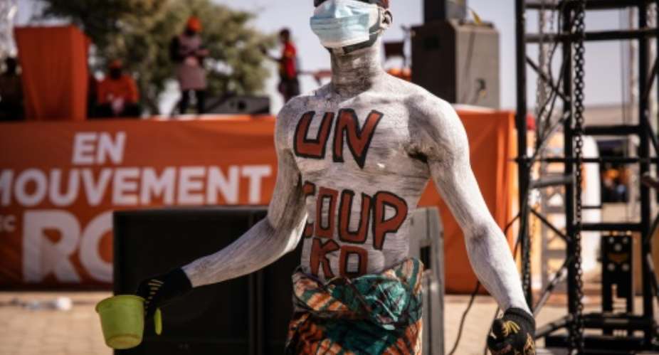 Body language: The message painted on this Kabore supporter reads: 'One punch -- knockout'.  By OLYMPIA DE MAISMONT AFP