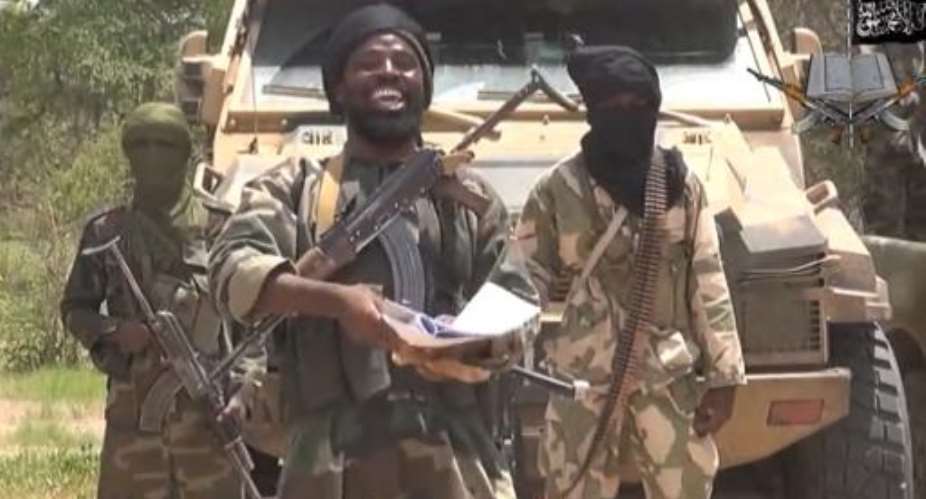 A screengrab taken from a video released by the Nigerian Islamist extremist group Boko Haram shows the leader of the Nigerian Islamist extremist group Boko Haram, Abubakar Shekau centre on July 13, 2014.  By Ho Boko HaramAFP