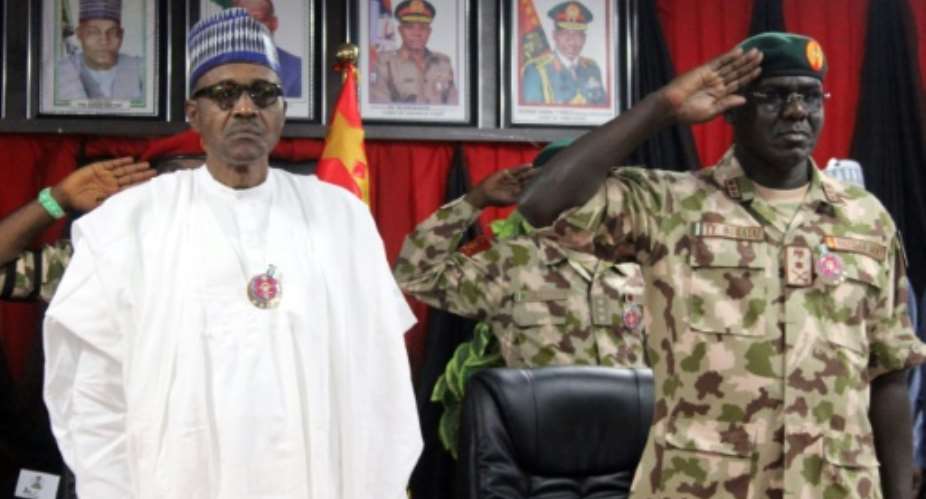Boko Haram jihadists attacked a village in Borno state near the family home of Nigeria Chief of Army Staff Lt. General Tukur Yusuf Buratai R, here with President Muhammadu Buhari.  By Audu MARTE AFPFile