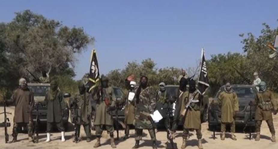 An image grab made on October 31, 2014 from a video obtained by AFP shows the leader of the Islamist extremist group Boko Haram, Abubakar Shekau C, delivering a speech.  By  Boko HaramAFPFile