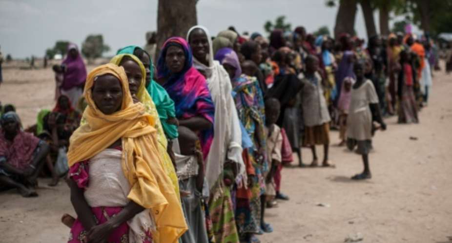 Women and children wait on June 30, 2016, to visit one of the UNICEF nutrition clinics, on the outskirts of Maiduguri, capital of Borno State, an area that has been torn apart for the last seven years by Boko Haram insurgents.  By Stefan Heunis AFPFile