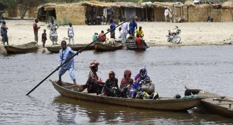 Residents cross an inlet of Lake Chad in N'Bougoua on April 6, 2015, which was attacked by Islamist group Boko Haram on February 12.  By Philippe Desmazes AFPFile