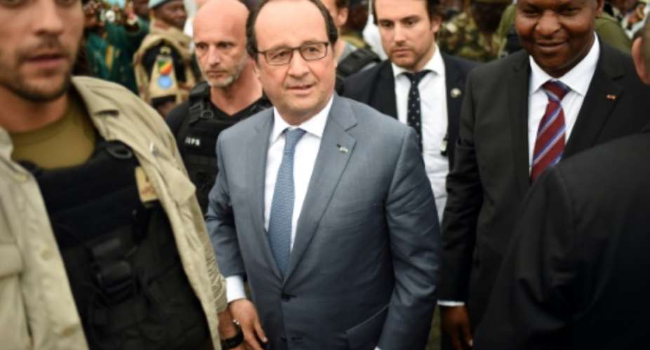 French President Francois Hollande and Central African Republic President Faustin Touadera visit the KM5 area of the CAR capital Bangui on May 13, 201.  By Stephane De Sakutin PoolAFP