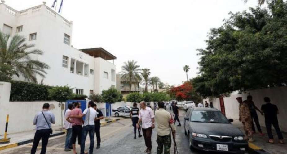 Security forces and residents gather in the street where a bomb exploded on May 18, 2013 in Tripoli, Libya.  By Mahmud Turkia (AFP)