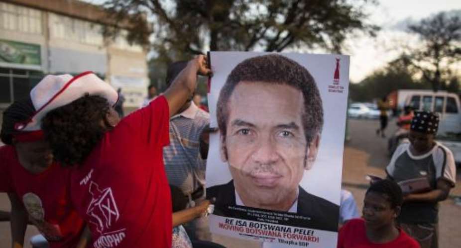Activists for the ruling Botswana Democratic Party BDP distribute posters with the picture of President Ian Khama at a pre-election gathering in Gaborone, on October 22, 2014.  By Marco Longari AFP