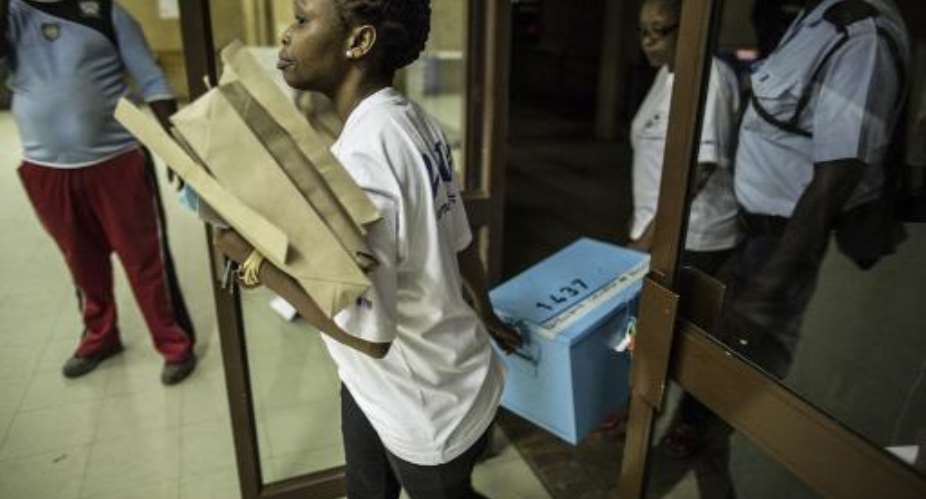 Polling officers bring ballot boxes to a counting center in Gaborone on October 24, 2014 after voting ends in the Botswana general election.  By Marco Longari AFP