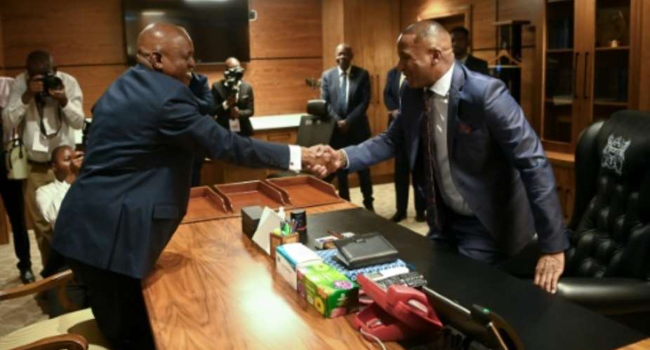 Botswana€s newly elected President Duma Boko (R) takes over from outgoing president Mokgweetsi Masisi after nearly 60 years of rule by the same party.  By Monirul Bhuiyan (AFP)