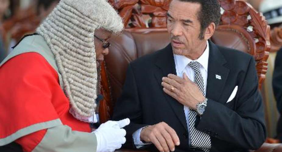 Botswanas President Ian Khama (R) talks with High court chief justice Maruping Dibotelo as he was sworn in for his second term on October 28, 2014 in Gaborone.  By Monirul Bhuiyan (AFP/File)