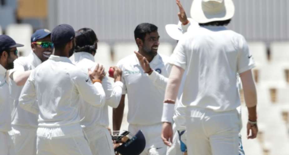 Bowler Ravichandran Ashwin C celebrates the dismissal of South African batsman Dean Elgar.  By GIANLUIGI GUERCIA AFP