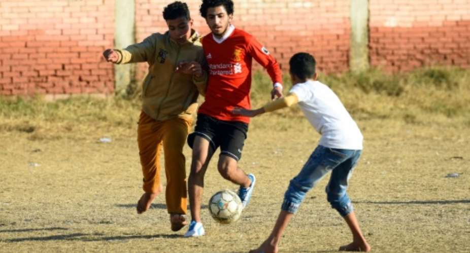 Boys play football at the Mohamed Salah Youth Center in the Egyptian village of Nagrig, the home village of Liverpool's top scorer and Africa's top player Mohamed Salah.  By MOHAMED EL-SHAHED AFP