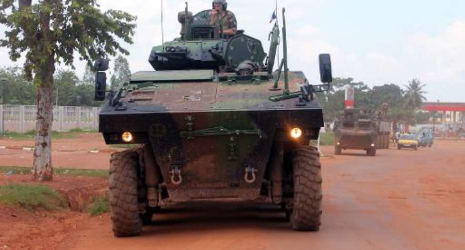 French Sangaris troops patrol aboard a military vehicule on August 16, 2014 in a street of Bangui, the Central African capital.  By Pacome Pabandji AFPFile