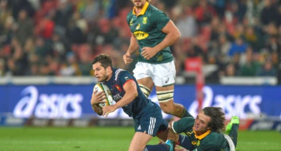 Brice Dulin of France L is tackled by Franco Mostert of South Africa during the third rugby union test match at Emirates Airline Park in Johannesburg, on June 24, 2017.  By Christiaan Kotze AFP
