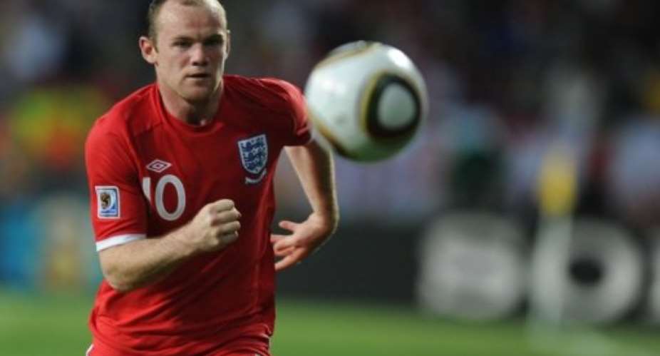 England striker Wayne Rooney runs with the ball.  By Patrick Hertzog AFPFile