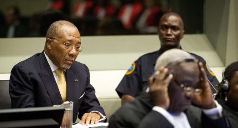 Former Liberian president Charles Taylor L pictured in the courtroom of the Special Court for Sierra Leone in The Hague prior to the appeal judgement on September 26, 2013.  By Koen van Weel PoolAFPFile