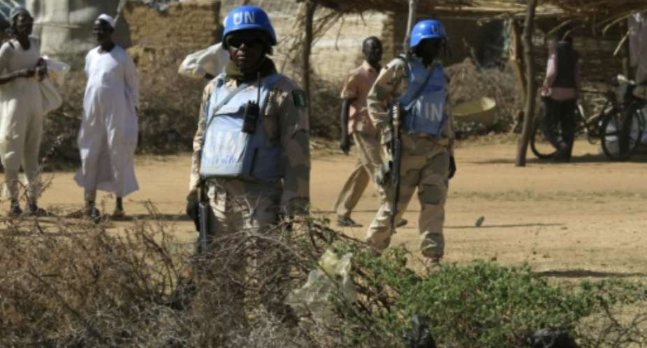 Peacekeepers from the UN-African Union mission to Darfur UNAMID patrol the Kalma camp for internally displaced people, located east of Nyala city in Sudan's Darfur, on November 6, 2014.  By Ashraf Shazly AFPFile