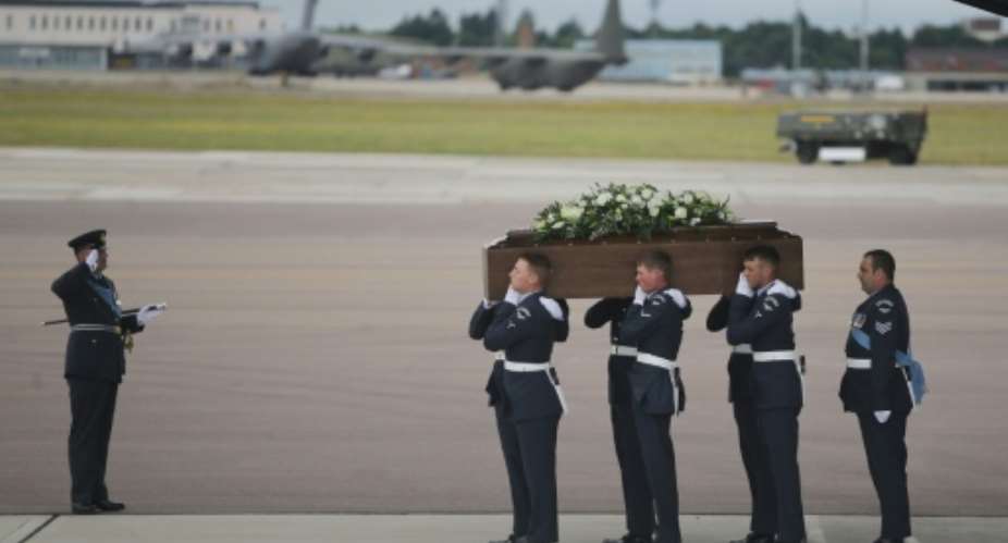 The coffin of Ann McQuire, killed in a gun massacre at a Tunisian beach resort, is taken from the RAF C-17 at RAF Brize Norton in Oxfordshire on July 2, 2015.  By Daniel Leal-Olivas POOLAFP