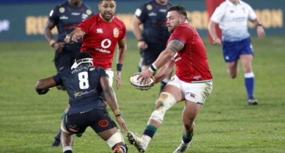 British and Irish Lions prop Rory Sutherland R passes the ball during a tour match against the Sharks in Johannesburg on July 7.  By Phill Magakoe AFP