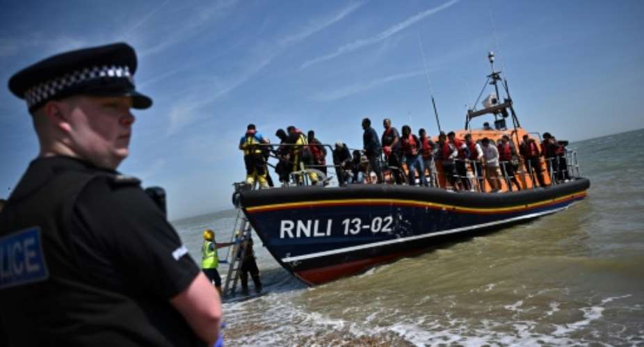 British MPs said there was no clear evidence the governments plan to deport some asylum seekers to Rwanda would discourage Channel crossings.  By Ben Stansall (AFP)