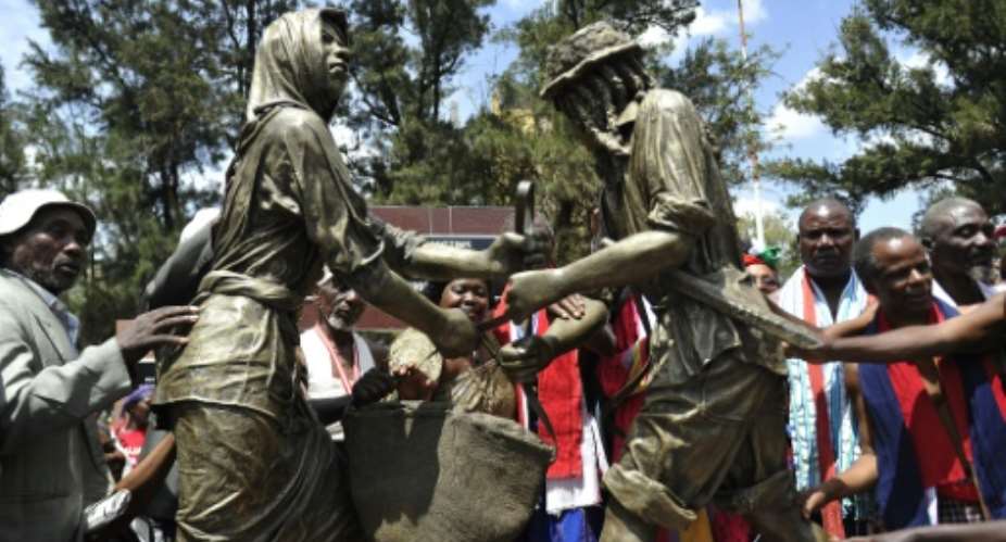 Kenyans attend the unveiling of the memorial dedicated to the thousands killed, tortured and jailed in the Mau Mau rebellion, during a ceremony in Nairobi, on September 12, 2015.  By Simon Maina AFP