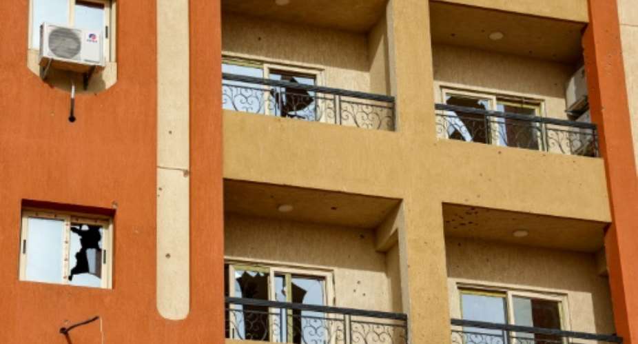 Broken windows at a residential building in Khartoum in the aftermath of fighting.  By - AFP