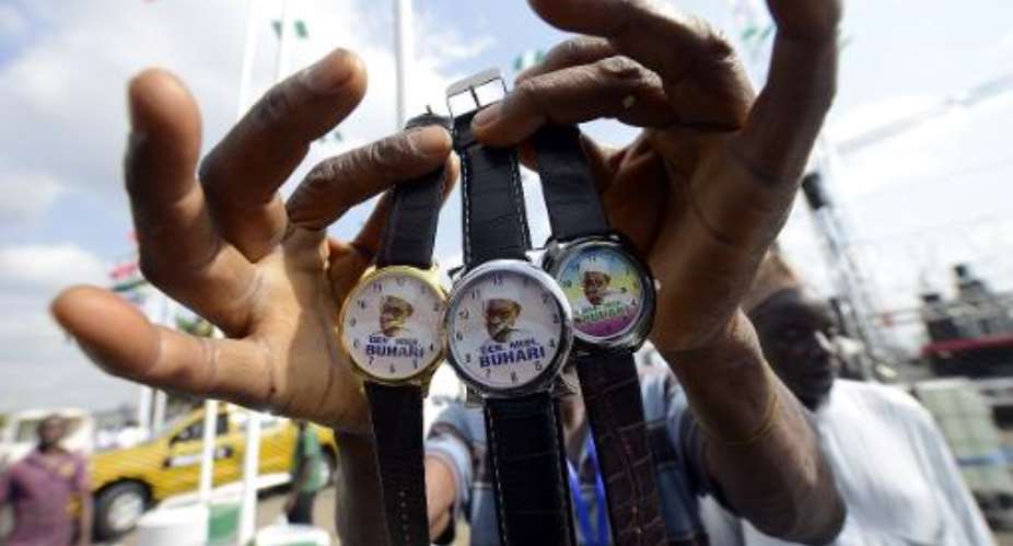 A vendor sells wrist watches with portraits of Nigerian president-elect Mohammadu Buhari ahead of a handover ceremony in Abuja, on May 28, 2015.  By Pius Utomi Ekpei AFP