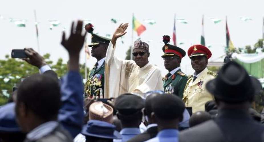 Nigerian President Muhammadu Buhari C waves to the crowd during his inauguration ceremony in Abuja on May 29, 2015.  By Susan Walsh PoolAFPFile