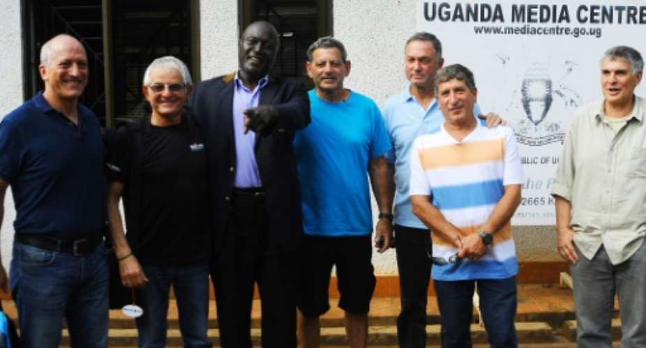 From L Eyal Oren, Shlomo Carmel, Jaffer Amin, Amjon Peled, Alex Davidi, unidentified, and Amir Ofer, members of the former Israeli Commandos and Entebbe hostages, pose for a photo in Kampala, on June 14, 2016.  By Ronald Kabuubi AFPFile
