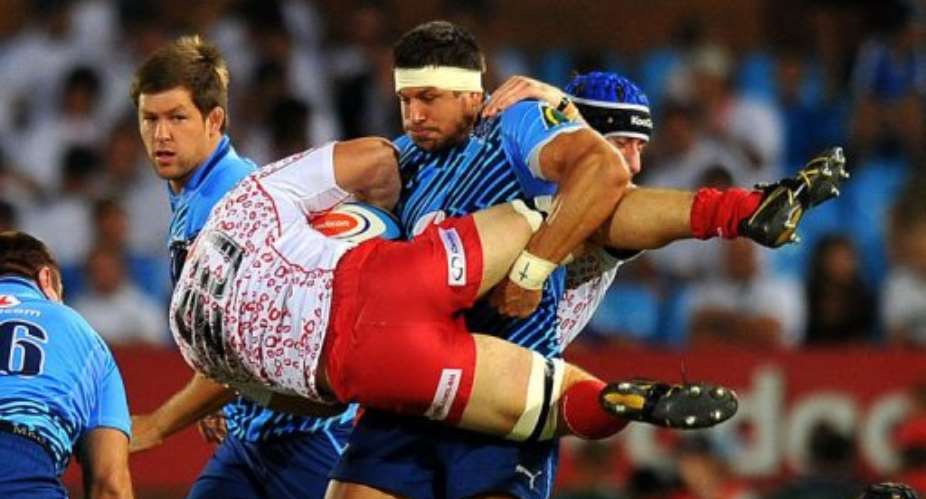 Jano Vermaak C of The Bulls tackles Liam Gill of the Reds.  By Alexander Joe AFP
