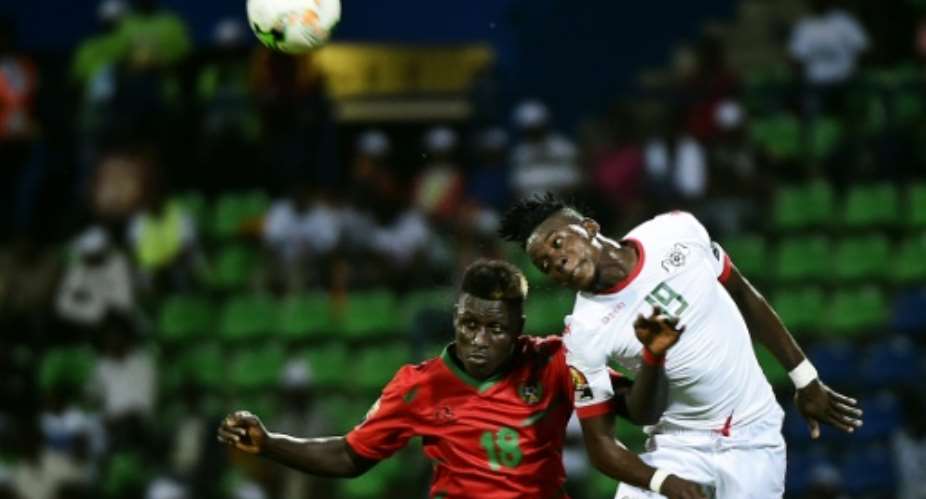 Burkina Faso's forward Bertrand Traore R challenges Guinea-Bissau's forward Piqueti during the 2017 Africa Cup of Nations group A football match between Guinea-Bissau and Burkina Faso in Franceville on January 22, 2017.  By KHALED DESOUKI AFP