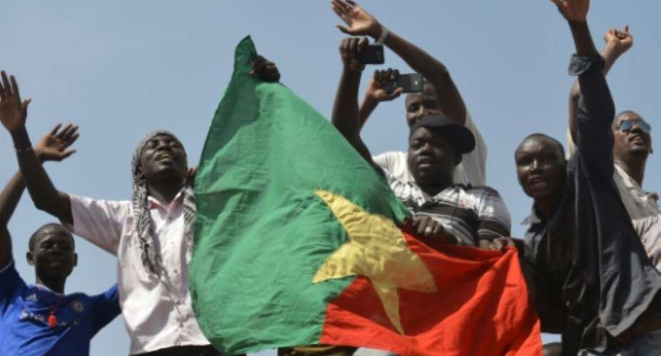 People celebrate after embattled President Blaise Compaore announced that he was stepping down in Ouagadougou on October 31, 2014.  By Issouf Sanogo AFPFile