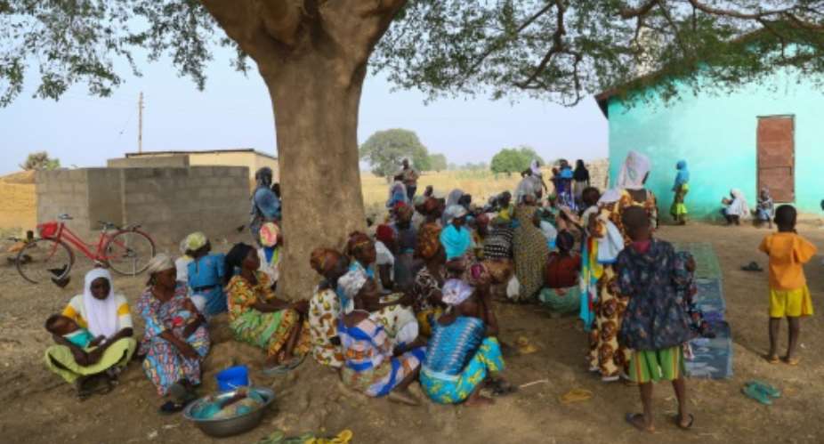 Burkinabe refugees gather under a tree at a settlement in Bawku, northern Ghana, where they fled after their hamlet was attacked across the border.  By Nipah Dennis (AFP)