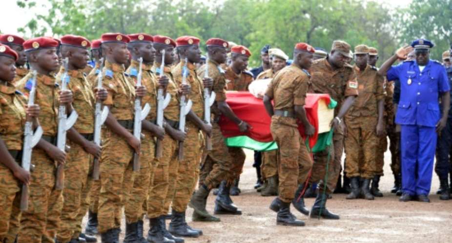 Burkinabe troops, seen attending the funeral of soldiers killed by jihadist groups in 2016, have made dozens of arrests in a sweep of violence-hit regions since the end of last year.  By AHMED OUOBA AFPFile
