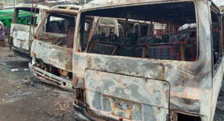 Burned vehicles at the bus terminal in Buea testify to the violence of Monday's clashes.  By - AFP