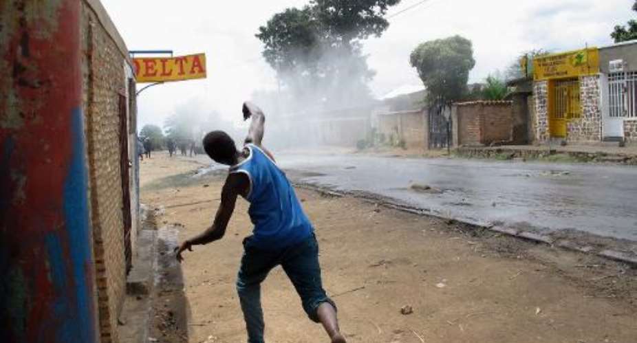 A protester throws stones at police during street battle in the Mugasa district of Bujumbura, Burundi, on May 4, 2015.  By Aymeric Vincenot AFP