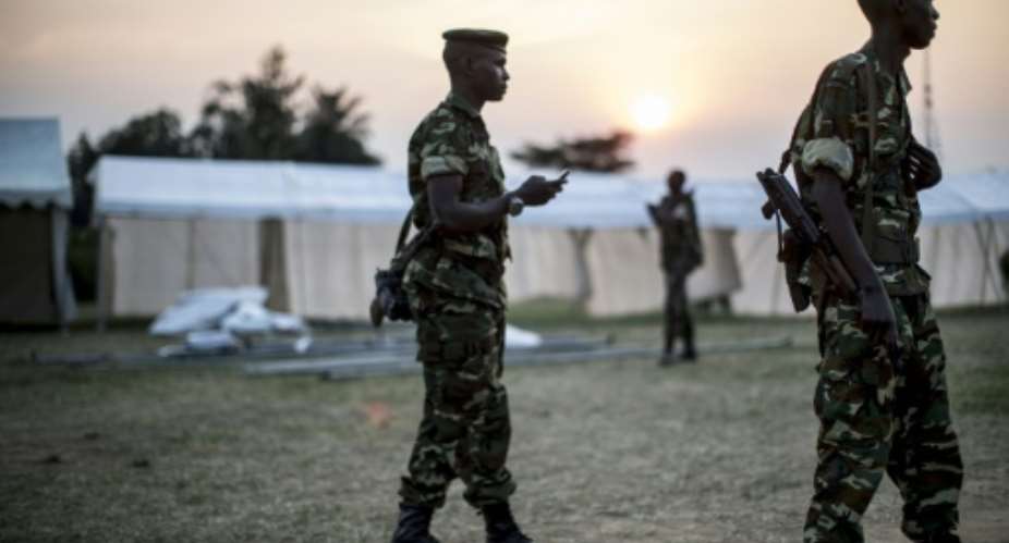 Burundian soldiers patrol during the construction of several marquees to be used as polling venues, on the outskirts of the Musaga neighbourhood of Bujumbura, on June 28, 2015.  By Marco Longari AFP