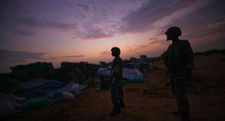 Soldiers serving with AMISOM are seen at daybreak manning frontline positions near Mogadishu in 2011.  By Stuart Price AFPAU-UN ISTFile