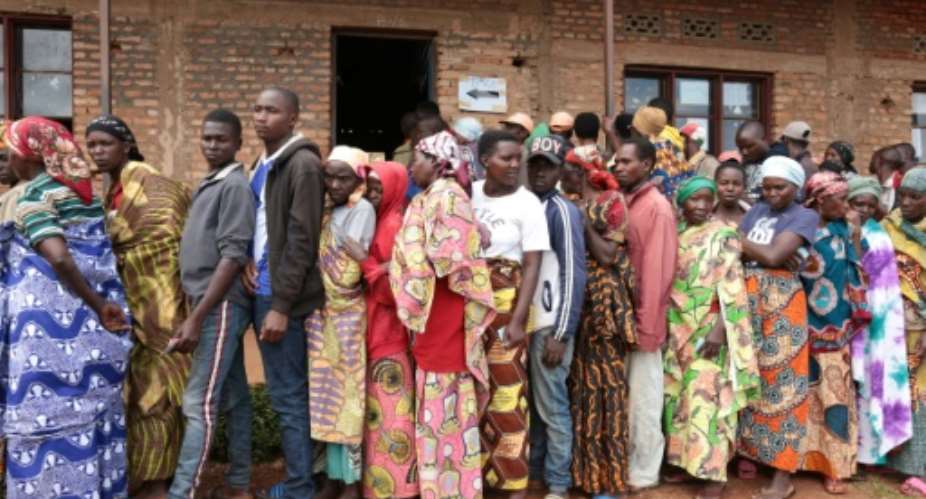 Burundians wait in line to vote in elections at a primary school in Giheta, with little attention paid to social distancing recommendations to curb the COVID-19 coronavirus.  By - AFP