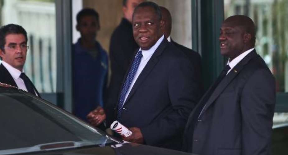 Confederation of African Football president Issa Hayatou C leaves after a meeting in Cairo on November 11, 2014.  By Mohamed el-Shahed AFPFile